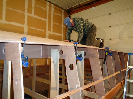 Screwing planks down.  Chine looks good so far.