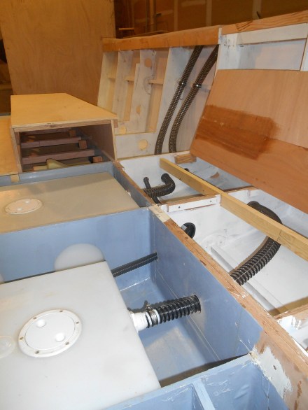 Hose runs starboard. The skinny hose is for a small bilge pump just ahead of the water tank.