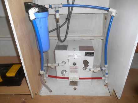 Water heater plumbing under sink