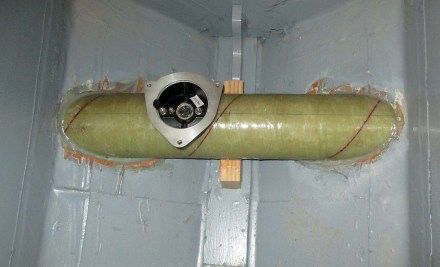 Tube and thruster lower flange tacked into the boat with epoxy.  Lots more glass work to come.